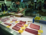 A worker cuts tuna fish in to smaller pieces, 2008